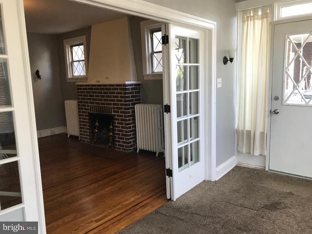 This large 3 bedroom 1.5 bath twin has been well maintained. The first and second floors feature original hardwood, with wood inlay, original wood moldings, baseboards, and doors. Fireplace in living room, french doors open to bright sun room, with large adjecent dining room. Fully fenced backyard with covered awning in park-like setting. Rear alley access to huge double garage with electrical -- perfect for workshop. Front roof singles are 6 months old, top roof was also inspected and caulked by licensed roofer at that time, roof was coated in 2006. The attention and care this property has received is impressive and a rare find. This property has excellent walk-ability too. Just blocks from Acme, Shop Rite, dining, shopping centers, Dunkin Donuts, bus, and train routes.Detached Garage, 2-Car Garage, 2 Total Garage and Parking Spaces, Street parking