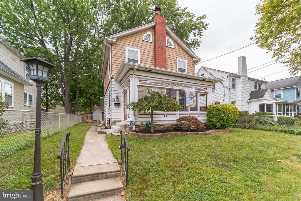 Welcome to this warm, colonial home located on a quaint street in Aldan! Enter through the spacious enclosed front porch into the open living room, which features a wood burning fireplace, classic hardwood floors, authentic wood ceiling beams, and ample natural lighting. The traditional kitchen includes granite countertops, stainless steel appliances, and custom floor-to-ceiling cabinetry. Just off the kitchen is a lovely dining room with french doors leading to a covered deck looking over the spacious backyard. The backyard features a fire pit area, perfect for entertaining throughout the year, and a storage garage. Upstairs, you will find three bedrooms, with plenty of closet space, a full bathroom, and continued hardwood flooring. Rest assured, knowing the bathroom plumbing and water heater are both new! Just a few blocks from the MacDade business corridor, and near great shops and restaurants including Cupcakeology, Cedar Craft & Kitchen, as well as several great Italian spots. Also, conveniently located near public transportation routes, including the Media/Elwyn rail line. Enjoy the outdoors by taking a walk through the nearby parks or along the Darby Creek. 63 Beech Ave is a beautiful colonial home, in a coveted location, and close to lots of amenities!