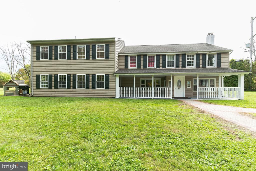 Welcome to this warm, beautifully-remodeled home located in picturesque Perkasie! Enter through the spacious covered front porch into the open living area, which features a bonus room to the right with a fireplace and built-in stone bar, a huge, open living room off the kitchen with tasteful laminate flooring, a home office, built-in speakers, recessed lighting and lots of windows. The contemporary kitchen includes granite countertops, cultured marble backsplash, under cabinet lighting, an island with breakfast bar, an electric stove, stainless steel appliances, and plenty of cabinet space. Just off the larger living room area is the secluded home office space and french doors leading to the rear patio and private backyard (big lot at 1.7 acres!). Upstairs, you will find the huge master suite, which features vaulted ceilings, skylights, a walk-in closet, a sitting area and a master bathroom with a soaking tub, double vanity, custom shower and ceramic tile. Off of the master is the laundry area and reading room perfect for morning coffee and a good book. The upstairs also includes 3 other large bedrooms with plenty of closet space. There's plenty of parking in the large garage with 4 parking spaces and an oversized garage door. Conveniently located near the business corridor on S. Dublin Pike and easy access to PA-611. Enjoy the outdoors by taking a walk through the beautiful neighborhood and nearby parks. A huge, beautifully remodeled home in a quiet neighborhood! Don't miss out and schedule your showing today!