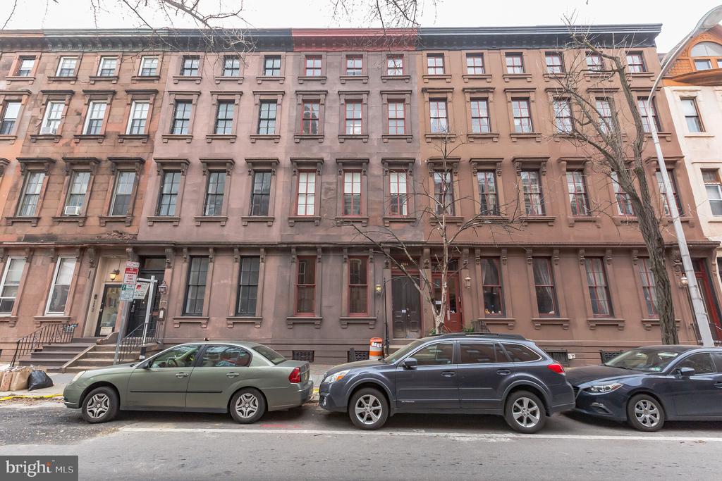 Welcome to this rare find in Rittenhouse Square! This stunning 2 bed 2 bath bi-level apartment with PARKING boasts original character, ample space, and detailed crown molding! This gorgeous unit  has so much original detail from the abundance of woodwork, to the hardwood floors, to the stained glass windows, to the 3 fireplaces. It's a perfect blend of old and new world. In addition to the kitchen, the first floor features 2 very large living spaces, each with fireplace. The upgraded kitchen offers a dishwasher, garbage disposal, granite counters/backsplash, and stainless steel appliances! The primary bedroom offers ample space with a walk-in closet. The en suite bathroom is beautifully crafted with modern design. The additional bedroom is also a great size. The second bathroom features a beautifully designed tile and a specialized sink. Private parking is included in the rent, which is never easy to find in Rittenhouse. Amazing centralized location on Pine St. with a Walk Score of 99. Close to all of Center City's amazing amenities.