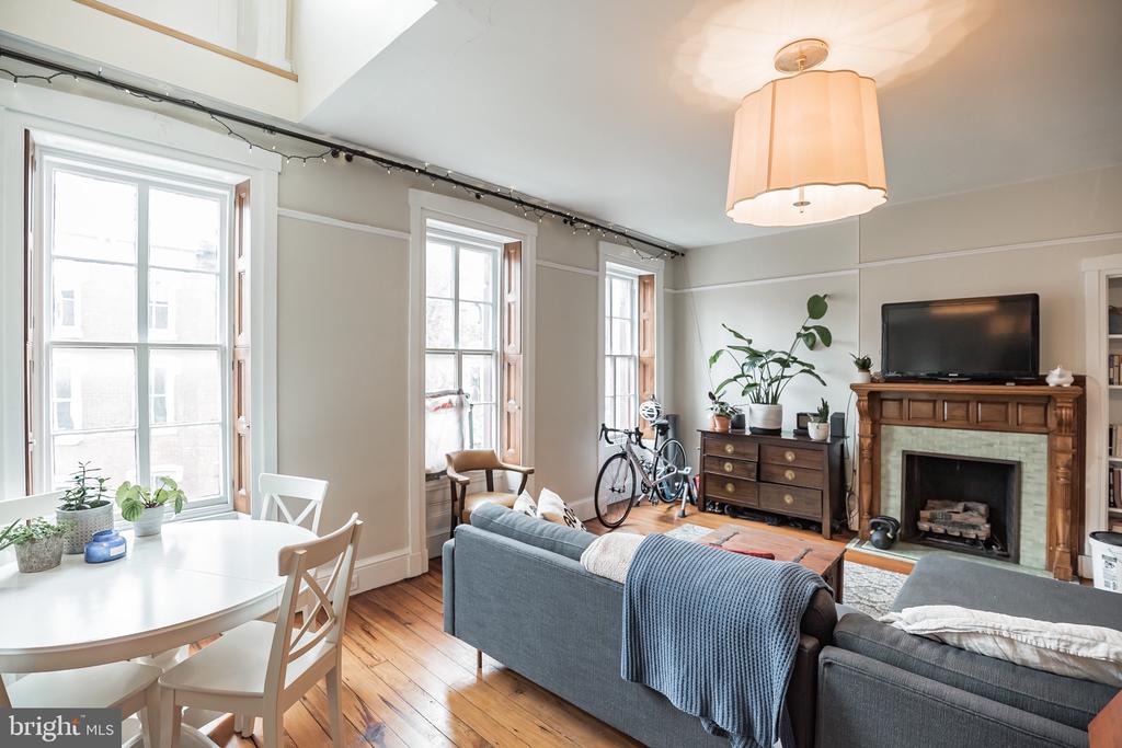 Welcome to this rare find in Rittenhouse Square! This stunning 3 bed 2 bath bi-level apartment boasts original character, ample space, and detailed crown molding! This gorgeous unit has so much original detail from the abundance of woodwork, to the original pine hardwood flooring, to the grand staircase, to the marble fireplaces. It's a perfect blend of old and new world. In addition to the kitchen, the first floor features a very large living space, with a fireplace, and the master bedroom, which includes an en suite bathroom with double vanity. The upgraded kitchen offers a dishwasher, garbage disposal, granite counters, and stainless steel appliances! On the second floor, you will find 2 generously sized bedrooms with plenty of closet space and a second full bathroom.  Amazing centralized location on Pine St. with a Walk Score of 99. Close to all of Center City's amazing amenities.