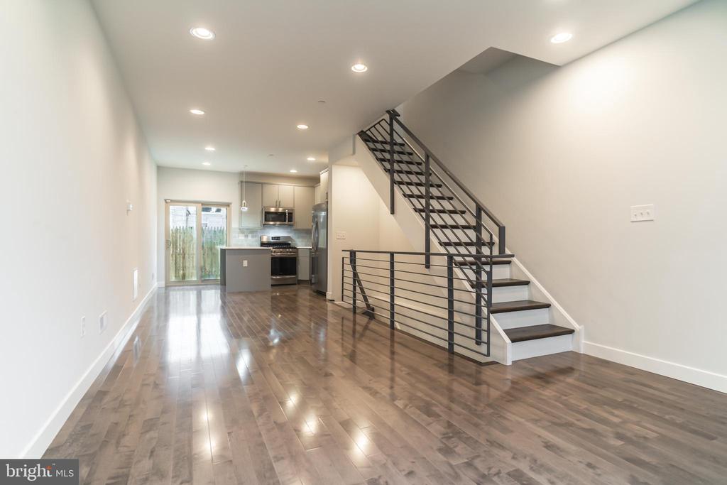 Beautiful new construction home located in the desirable Norris Square neighborhood! Come visit this incredibly well done new build on a block surrounded by new construction homes and opportunities. Get in now and watch your value climb! Enter in through the front door into a sprawling living area with hardwoods that stretch back to the modern kitchen! The all stainless steel appliances accentuate the contemporary feel. The private back patio sits right out back of the main floor, perfect area for grilling this summer! The basement level provides an extra room with a full bath as well as a state of the art laundry room. Heading up to the second floor, the stairs are accented by a gorgeous modern rail. The second floor provides two spacious bedrooms with another gorgeous full bath! Heading up one more level you will enter the owner's suite! Very well done, this suite showcases an oversized bedroom, ample closet space and a magnificent full bathroom with shower stall! Lastly, head up one more level and take in your own slice of the Philly skyline with your private roof deck. Perfect for entertaining! This home comes with a full 10 year tax abatement!
