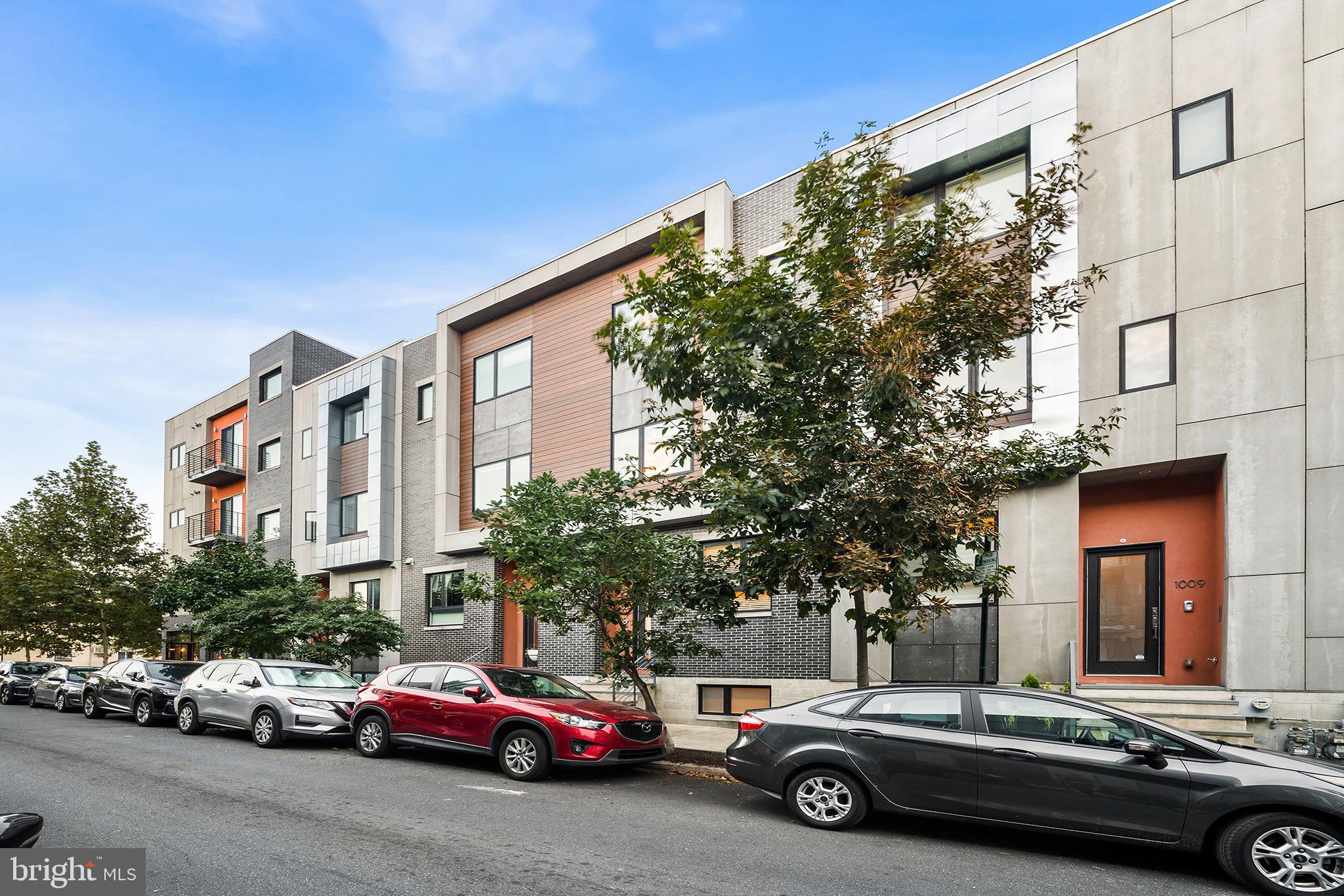 Welcome to 1007 S 17th Street, where charm, warmth, and exquisite modern details are the highlights of this entertainer's dream home. This inspiring, three-story row features an open floor plan with smart home amenities. Offering a gated drive isle with attached two-car garage for coveted city parking, breathtaking views of Philadelphia's skyline from a private roof deck, and three years remaining on tax abatement.
Enter through the front door and step into the main level exuding modern luxury. Be greeted by a designer kitchen featuring stainless steel appliances, designer cabinetry, white countertops, subway tile backsplash, and an extra-large window providing all the natural light a chef desires.
Past the dining area, the steel-framed floating staircase is a beautiful touch to an expansive living room with a brick accent wall, a TV/Fireplace buildout with shelves and double glass sliding doors leading out to a generously sized outdoor terrace. 
Spacious enough for an in-home gym, office space, man-cave, or even an additional guest bedroom with its full bathroom, check out the basement area that is private and roomy.
Head upstairs to the second level to find two large bedrooms featuring two closets with plenty of space for customization and windows with greenery views. Complete this level by touring a full bathroom and a conveniently placed laundry room with a tiled floor, sink, and wet bar. The stunning Master suite third floor includes a spa-like, en-suite bathroom featuring a stylish vanity and glass-enclosed full tiled shower with sliding doors.
The crowning jewel of the home is the rooftop deck with jaw-dropping panoramic views of the city skyline. Wind down after a long day and enjoy a glass of wine from your wet bar and wine fridge and take in the stunning views. 
The whole house has been freshly painted and has two Nest thermostats, a new AC compressor, and a brand new chandelier with smart home lighting switches. The outside lights and bookshelves also turn on and off automatically, and motion sensor lighting is present in the garage.
You'll adore the Graduate Hospital community, adjacent to Fitler Square and Rittenhouse Square neighborhoods, live within proximity to Center City, and enjoy a variety of coffee shops, retail boutiques, gastropubs, wine bars, and fine restaurants. Experience your morning coffee at Ultimo Coffee, lunch at Honey's Sit and Eat, and happy hour at SideCar. Stretch your legs at nearby Julian Abele and Marian Anderson parks and the Schuylkill banks waterfront walking trails. Welcome home!