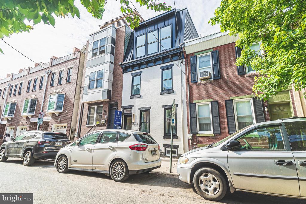 Magnificent home in the highly sought after Philadelphia neighborhood of Graduate Hospital! Built meticulously with high attention to detail, this home has all of the luxury finishes you could ever ask for! Nestled on a beautiful, tree-lined street just south of Rittenhouse Square, this 4 bedroom & 2.5 bath gem is a sight to be seen. Take a stroll along this low-traffic, walkable street and arrive home to the magnificent sight of white brick paired perfectly with black accents. As you enter through the front door, you will immediately notice the natural light pouring in from the living room windows and sprawling across the wide plank Malibu Chestnut hardwood floors. Midway through the first floor, the floors meet a gorgeous quartz countertop with waterfall finish, which is one of many amazing details. The high-luxury, low-maintenance quartz countertops are accented by magnificent veining alongside the matte black faucet and brass cabinet hardware. Expanding further past the kitchen is your spacious dining room with a custom light fixture! Before you head outside to the first of three outdoor areas, you will come across the strategically-placed wet bar and half bath. Both are ideal for entertaining on the patio! The basement provides ample storage space as well. Taking the stairs to the second level, it will be hard to miss the modern iron rails. The second level is highlighted by 3 spacious bedrooms and the first full bathroom! No need for 3 bedrooms? The middle room doubles as a WFH space with plenty of natural light flowing through the breezeway window. Heading up the stairs once more to the primary suite you will immediately be greeted by the second outdoor space! A third floor balcony with skyline views. Slide open the barn-style door, and you will see that this suite truly has it all. In the en suite bathroom, dark tile pops with gold accents alongside a massive shower stall and soaking tub! Down the hall, past the walk-in closet, you will be greeted with more natural light pouring in through the large bedroom windows. From the primary suite, this home offers one more secret: a stairway to the private roof deck! The panoramic views from the roof deck are simply breathtaking, as the skyline reaches toward the clouds! And just when you thought everything you saw was too good to be true, this home comes with a rare/full 10 YEAR TAX ABATEMENT! Schedule your private tour today, this home will not last long! Owner is a Licensed PA Broker.