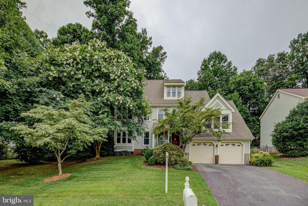 Beautifully Updated Multi-Level, Contemporary Style Colonial Home with 5 Bedrooms & 3 Full Baths in Sought after Cabells Mill Neighborhood.  This lovely home shows like a Model (Charleston/Loft model) with almost 3,000 sq. ft. of living space, perfect for Guests & Large-Scale Social Gatherings.  This Exciting Floor Plan offers a 2-story Family Room, Main Level Bedroom & Bath (great as a Guest, Au Pair Suite, Office, or Primary Bedroom as you prefer), Light Filled Rooms & Multi-Level Living with Private Bedroom Suites throughout the home.  As you enter the home the Large Formal Living Room Welcomes you with HW Flooring, Large Windows & Recessed Lighting.  The Main Level Features HW Flooring throughout with a Renovated Kitchen (2014), a Large Island & BBar, Granite Countertops & Backsplash, New Cabinetry, SS Appliances w/ Gas Cooking, and Under-Cabinet & Recessed Lighting.  The inviting Family Room off of the Kitchen Boasts of a Vaulted Ceiling with 2 Skylights, a Cozy Gas Fireplace, & Built-in Shelving.  The Elegant Formal Dining Room off the Kitchen Features Crown Molding, Chair Railing, Stylish Lighting & Lovely Views of the Rear Yard.   The Spacious Primary Bedroom Features Elegant Crown Molding, a Walk-in Closet & a Renovated Luxury Bath with Double Sinks, Granite, Updated/Recessed/Mood Lighting, Cabinetry & a Grand Frameless Walk-in Shower with an Oversized Convenient Bench.   Additional Baths have been recently renovated & updated too.  Additional Bedrooms are Spacious with the 2nd Level Bedroom having a Vaulted Ceiling & Large Windows with a 4th Level Room Great as a 5th Bedroom, Office or Game Room with an additional A/C Unit for perfect comfort.  This house is Turnkey...all of the major components have been updated...Roof Replaced in 2012 w/ 20-year Warranty, Carrier HVAC replaced in 2018, Fantastic "On Demand" High-Capacity Instant Hot Water, No Maintenance Vinyl Wrapped Windows & Siding, & New Carpeting.  The Lower Level offers additional storage or living space with 2 Full Windows and it is already Plumbed for a 4th Bathroom should you desire.  The exterior of the home offers total privacy with lovely flowering trees & plants that features a Common Area in front of the home with great views.   Walkout to the Private & Spacious Deck which provides steps to the lower level yard backing to trees & privacy fencing for your total enjoyment.  The rear deck also has a direct gas connection for your grilling & entertainment needs.  Take advantage of the Low HOA (only $150.00/year), Top Rated Fairfax County Schools & Enjoy the Eleanor C. Lawrence Park just around the corner with Walking & Nature Trails!  So Close to Shopping Centers such as Fair Lakes Shopping Center, Fairfax Corner & Fair Oaks Mal & Wegmans!  Near Major Commuting Routes such as I-66, FFX Co. Pkwy., Rts. 50, 28, & 29 with easy access to Commuter Park & Ride Lots.  For a Suburban Retreat that offers sophistication and comfort, you've found it....JUST MOVE IN & ENJOY!!
