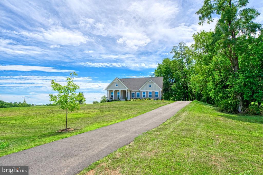 No HOA! Built in 2020! Gorgeous modern farmhouse style rancher with craftsman millwork! Stunning open floorplan with main level primary suite with access out to beautiful covered trex deck. Spectacular private setting at the back of a cul-de-sac on 2.35 acres with usable open land and surrounded by trees. Backs to conservancy lot and trees. Setting is unimaginably peaceful and gorgeous. Impressive modern gray kitchen with quartz counters and mega island, farmhouse sink in island, tons of cabinets, beautiful stainless steel appliances, subway tile backsplash and large corner pantry. Kitchen overlooks epic family room with custom modern electric fireplace and impressive surround. Craftsman style trimwork throughout. 3 bedrooms plus an office and 2 full bathrooms on main level. Huge primary suite with tray ceiling, his and her enormous walk in closets and modern bathroom with separate double raised vanities and stand up shower. Laundry room with shelving off garage on main level. Two car side load garage. Two large secondary bedrooms on main level! Gorgeous office with glass French doors on main. Massive, mostly finished basement level with huge open recreation room and rough in for full bathroom and potential for 2 additional true bedrooms with egress windows. Rough in for bathroom in basement. Septic perced for 5 bedrooms! Massive unfinished basement area currently being used as storage and work out area.