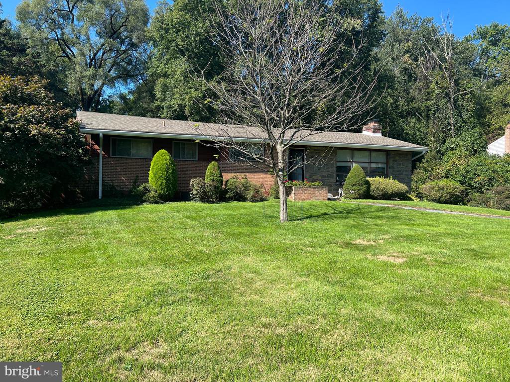 Rydal in Jenkintown - Welcome to this desirable Crosswicks neighborhood in the award-winning Abington School district.  This 3 bedroom, 2.5 bathroom ranch style home does need some TLC but, the possibilities to make this property your own are endless.  The home sits on a quiet, tree-lined street and features an unusually large lot size for the neighborhood.  The home features a large living room with cathedral ceilings, a wood fireplace, and a wrap-around outdoor screened-in deck that leads to the kitchen area.  The dining room and kitchen need updating but, are very spacious and could be easily opened up to your liking.  The property has 3 large bedrooms and a master bathroom that just needs to be completed.  The master bedroom also has a private, screened-in deck area.  There is wall-to-wall carpet throughout the home but, the hardwood floors underneath are just waiting to be brought back to life.  The large walkout basement and two-car garage are on the lower level and lead to a wonderfully large and private rear yard that features a small basketball court and an outdoor stone grill.  The large rear yard can be turned into your own personal paradise.  Whether it's adding a pool or a large firepit area, the rear yard has all the room you will ever need.  The property is in need of updating but, the main components of the home are in decent shape.  The roof was installed in 2019 and a new HVAC system in 2021.  The property is being offered "as-is" so, bring your contractor and schedule your showing today.